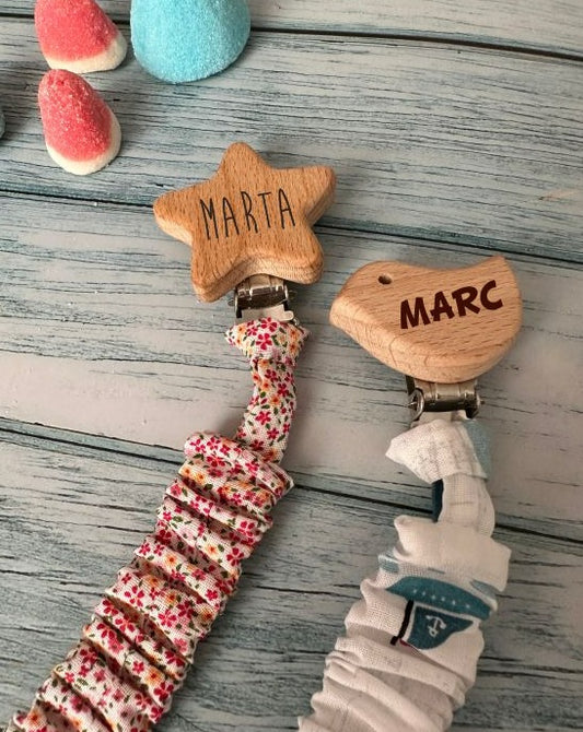 Personalized wooden and elastic fabric pacifier holder.